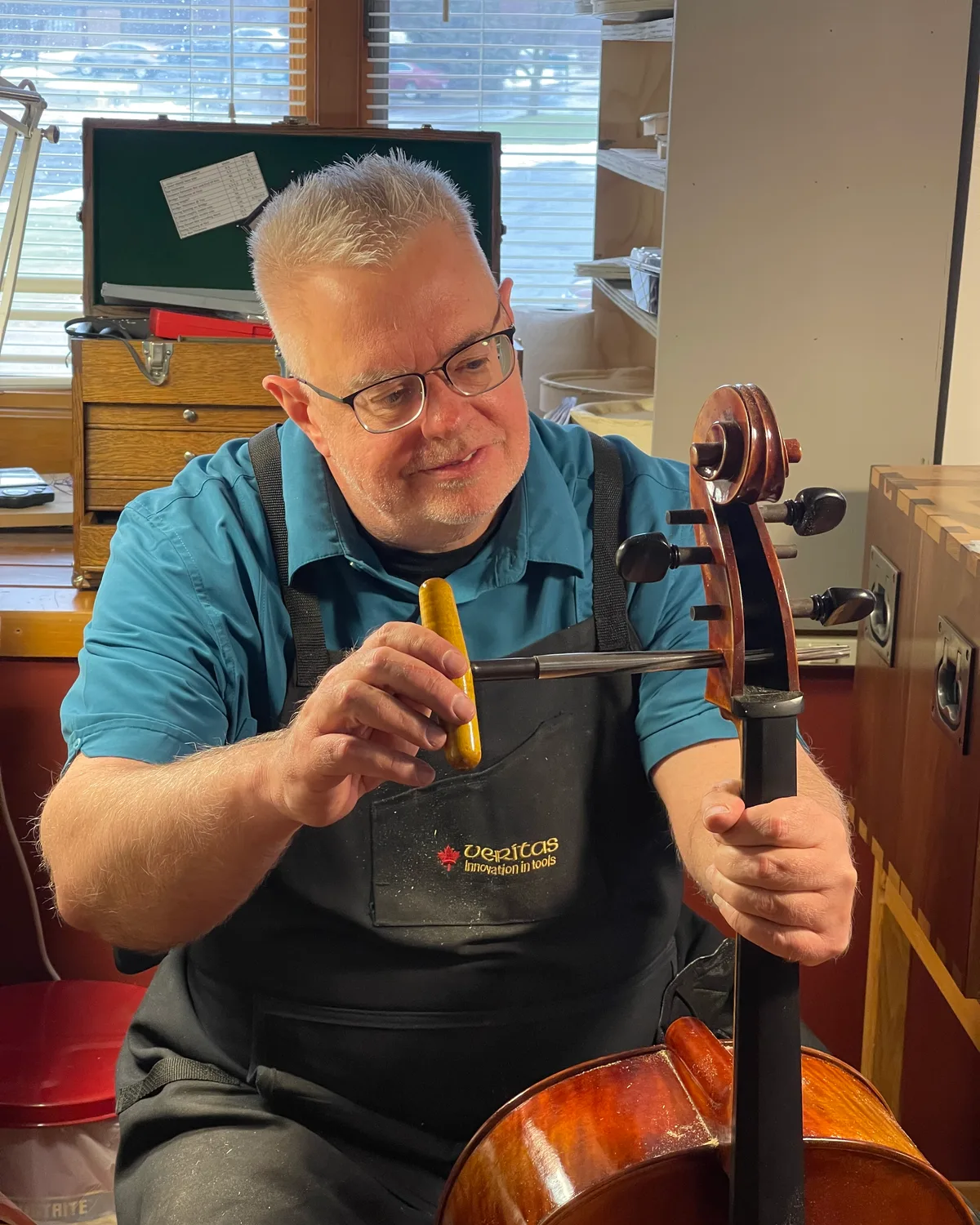 Peter Lynch shaping a cello peg at the bench.